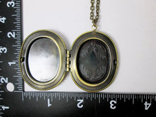 Load image into Gallery viewer, inside view of large oval locket