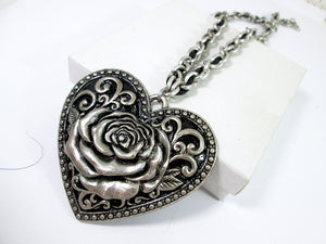 close up of large rose heart necklace