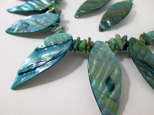 closeup view of teal shells necklace