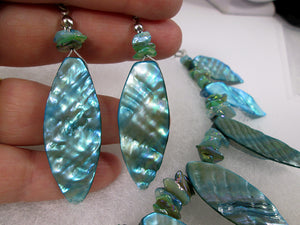 closeup view of iridescent teal shell leaf earrings