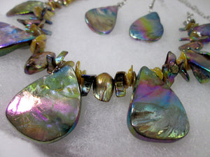 closeup view of rainbow bronze seashell and pearl necklace and earrings set