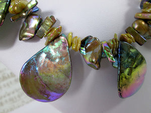closeup front view of rainbow bronze seashell and pearl necklace and earrings set