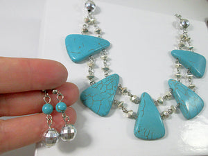 closeup view of turquoise statement necklace and earrings set
