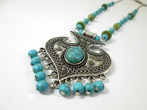 closeup view of turquoise tassel necklace 