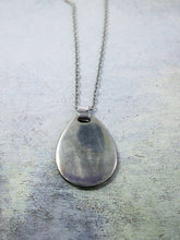 Load image into Gallery viewer, back view of horoscope pendant on metal chain,, pendant polished to mirror finish.