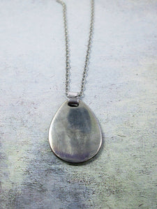 back view of horoscope pendant on metal chain,, pendant polished to mirror finish.