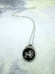Sagittarius pendant necklace on metal chain, teardrop pendant with black background, for man or woman. (picture taken on a white background)