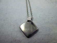 Load image into Gallery viewer, showing back of pendant on metal chain, polish to perfection with mirror finish
