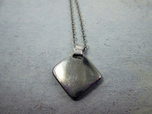 showing back of pendant on metal chain, polish to perfection with mirror finish