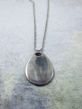 Load image into Gallery viewer, close up back view of horoscope pendant necklace on metal chain showing mirror finish