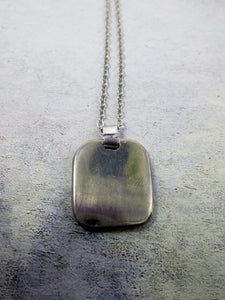 back view of zodiac animal pendant on metal chain, pendant polished with mirror finish.
