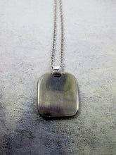 Load image into Gallery viewer, showing back of zodiac pendant on metal chain, pendant polished to mirror finish.
