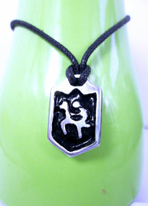 handmade pewter horse rider pendant necklace, pendant with black background, on black cord, for men or women. (photo taken of necklace on a green background)