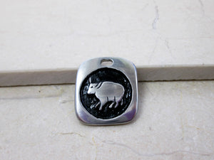 Year of the ox Chinese zodiac pendant for unisex, squarish pendant with black background. (picture taken on a marble background)