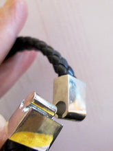 Load image into Gallery viewer, black braided leather cuff bracelet with slide lock clasp, close-up.
