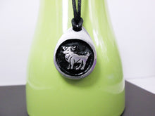 Load image into Gallery viewer, Aries horoscope necklace pendant with black background, teardrop shape, on black cord. For man or woman. (photo taken on a green background)