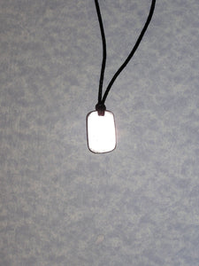 back view of maple leaf pendant on black cord, showing pendant polished to mirror finish.
