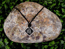 Load image into Gallery viewer, Kanji symbol for Good Luck pendant with black background, black cord necklace style.