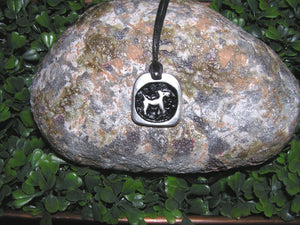 Year of the Dog Chinese zodiac pendant necklace for unisex, squarish pendant with black background, cotton cord style. (picture taken on a background with a rock)