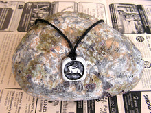 Load image into Gallery viewer, Year of the rabbit or bunny Chinese zodiac pendant necklace for unisex, squarish pendant with black background, cotton cord style. (picture taken on a background with a rock)
