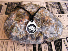 Load image into Gallery viewer, Taurus horoscope pendant necklace on black cord, teardrop pendant with black background, for man or woman. (picture taken on a background with a rock)