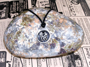 Gemini horoscope pendant necklace on black cord, teardrop pendant with black background, for man or woman (picture taken on a background with a rock)
