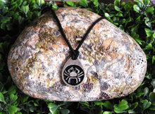 Load image into Gallery viewer, Cancer pendant necklace on black cord, teardrop pendant with black background, for man or woman. (picture taken on a background with a rock)