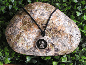Virgo horoscope pendant necklace on black cord, teardrop pendant with black background, for man or woman. (picture taken on a background with a rock)