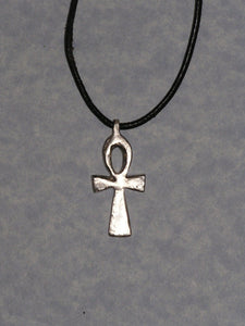back view of handmade ankh cross pendant necklace on black cord, showing pendant polished to mirror finish.