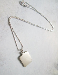 back of pendant, showing pendant polished to mirror finish.