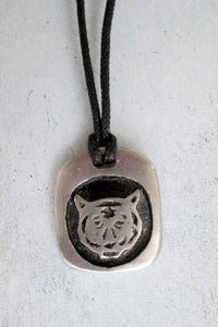 Year of the tiger Chinese zodiac pendant necklace for unisex, squarish pendant with black background, cotton cord style. (picture taken on a white background)