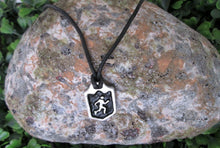 Load image into Gallery viewer, handmade pewter runner or jogger pendant necklace, pendant wit black background, on black cord, for men or women. (photo of necklace taken on a background with a rock)