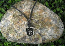 Load image into Gallery viewer, handmade pewter volleyball player pendant necklace, pendant with black background, on black cord, for men or women. (photo of necklace taken on a background with a piece of rock)