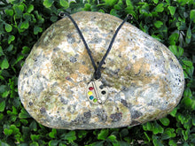 Load image into Gallery viewer, Artist palette pendant necklace on black cord, with painted paint sports, for unisex teen or adult. (photo taken on a background with a rock)