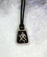 Load image into Gallery viewer, handmade pewter hockey goalie pendant necklace, polygon pendant with black background, for men or women, on black cord. 