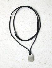 Load image into Gallery viewer, back view of ringette player pendant on adjustable cotton cord.  Picture showing pendant polished to mirror finish.