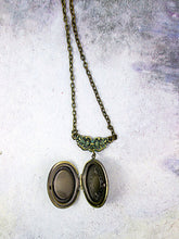 Load image into Gallery viewer, inside view of small oval locket