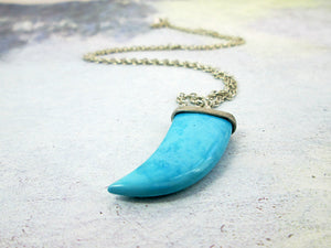 closeup picture of turquoise fang pendant