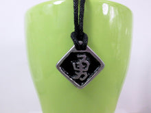 Load image into Gallery viewer, Kanji symbol for Courage or Bravery pendant with black background, black cord necklace style.