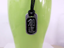 Load image into Gallery viewer, Kanji symbol for creativity pendant with black background, black cord necklace style. 