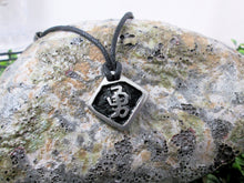 Load image into Gallery viewer, Kanji symbol for Courage or Bravery pendant with black background, black cord necklace style.