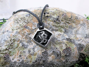 Kanji symbol for Courage or Bravery pendant with black background, black cord necklace style.