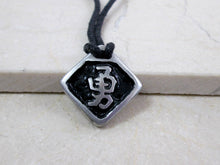 Load image into Gallery viewer, Kanji symbol for Courage or Bravery pendant with black background, black cord necklace style.