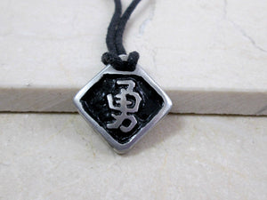 Kanji symbol for Courage or Bravery pendant with black background, black cord necklace style.