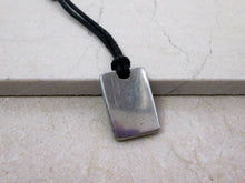 Load image into Gallery viewer, back view of IT computer geek pendant on black cord.  Picture showing pendant polished to mirror finish.
